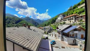 a view of a town with buildings and mountains at ALBERGO BELVEDERE in Orasso