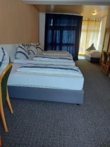 a bedroom with two beds in a room at Hotel -Pension-Weller in Mühlheim