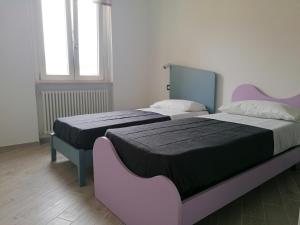 Posteľ alebo postele v izbe v ubytovaní Vasto in centro