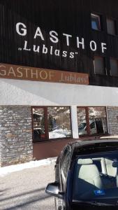 a black car parked in front of a store at Gasthof Lublass in Matrei in Osttirol