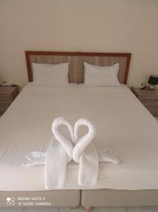 a bed with two white towels on it at Panorama in Elafonisi