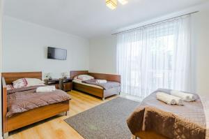 a bedroom with two beds and a window at Ramzes in Ustka