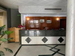 a lobby with a reception desk in a building at Hotel Tunisie Confort in Tunis