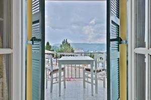 a view from a balcony with a table and chairs at Fotini Studios in Paleokastritsa