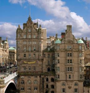 an old building in the middle of a city at The Scotsman Hotel in Edinburgh