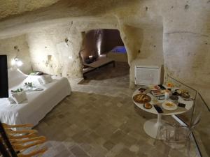 a bedroom with a bed and a table with food on it at LA DIMORA DELLE 3 ZIE in Matera