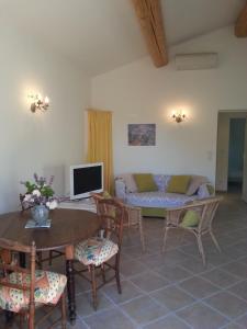 sala de estar con sofá, mesa y sillas en Charmante Petite Maison & Spa à Bulles & Grande Terrasse Plein SUD !, en Entrecasteaux