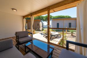 een kamer met een balkon met een stoel op een terras bij VILLAGE CLUB LES SABLONS in Portiragnes