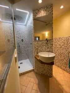 a bathroom with a sink and a shower at B&B Marina in Fosdinovo