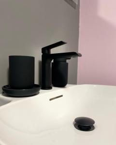 a black faucet sitting on top of a table at Tomosmatik Apartments Koper by Locap Group in Koper