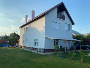 une maison blanche avec une grande cour dans l'établissement Andrea Apartman, à Balatonfüred