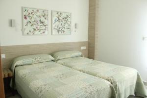 two beds sitting next to each other in a bedroom at Gazteategi in Zarautz
