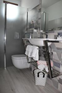 a bathroom with a sink and a toilet and a mirror at Gazteategi in Zarautz