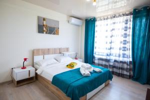 a bedroom with a bed with a teddy bear on it at Casa Angy in Techirghiol
