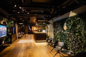 a lobby with chairs and plants on the wall at Rioca Vienna Posto 1 in Vienna