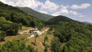 a house on a hill in the middle of a mountain at Staulir Affittacamere in Meduno