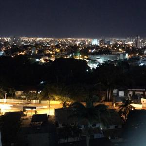 a view of a city at night with lights at Flat The Expression 1210 in Goiânia
