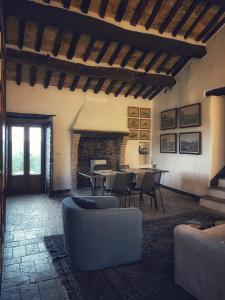 Country House Ca' di Nieri - The Saints' Lodge في Monte Santa Maria Tiberina: غرفة معيشة مع طاولة وكراسي