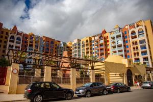 a group of cars parked in front of buildings at Apartamento Turistico VerdeMar 2 in La Manga del Mar Menor