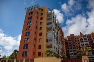 a tall building in front of some buildings at Apartamento Turistico VerdeMar 2 in La Manga del Mar Menor