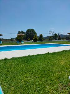 a swimming pool in the middle of the grass at Vigla House in Sykia Chalkidikis