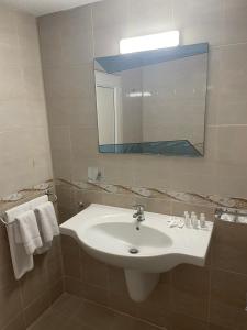 a bathroom with a sink and a mirror and towels at Hotel ECO Palace in Primorsko +23 photos
