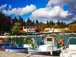 a group of boats docked in a harbor at Paraskevi Apartments in Ipsos