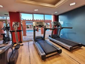 a gym with three tread machines in a room at Bay la sun , Luxury apartment with nice view in King Abdullah Economic City