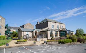 a building on the corner of a street at The Melbreak Hotel in Great Clifton
