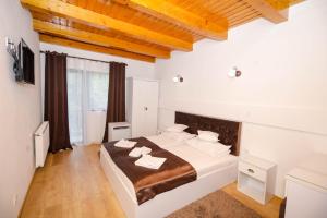 a bedroom with a large bed in a room at Casa Marica in Băile Herculane +20 photos