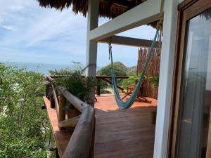 a view from a balcony of a patio with a view of the ocean at El Alquimista Yoga Spa in Zipolite