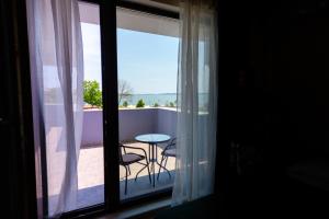 a view of a balcony with a table and chairs at Casa Angy in Techirghiol