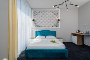 a bed room with a white bed and a white bedspread at Aquila Hotel in Zator