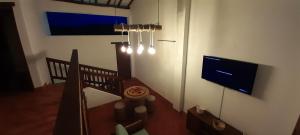 a room with a staircase with a flat screen tv at Alemau´s House Casa Hospedaje en Barichara in Barichara