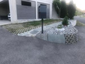 a parking lot with a sign in front of a house at Tina in Villeneuve