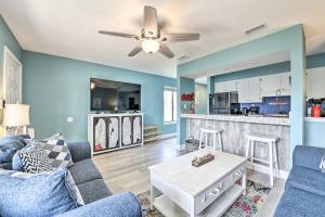 a living room with a couch and a table at Panama City Condo w/ Balcony & Pool, Walk to Beach in Panama City Beach