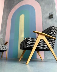 a chair sitting in front of a wall at Tomosmatik Apartments Koper by Locap Group in Koper