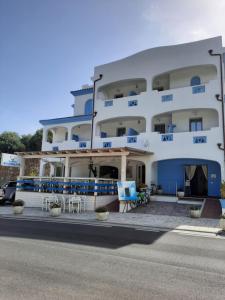 a large white building with tables and chairs in front of it at Hotel Made in Posada