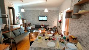 a dining room and living room with a table and chairs at Rodzinne Siedlisko in Biskupiec +22 photos