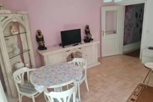 a living room with a table and chairs and a tv at Ferienwohnung Laura in Bad Reichenhall