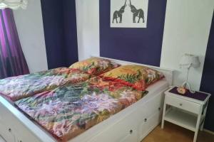 a bed with colorful sheets on it in a room at Ferienwohnung Laura in Bad Reichenhall