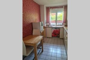 a small kitchen with a table and a refrigerator at Ferienwohnung Laura in Bad Reichenhall