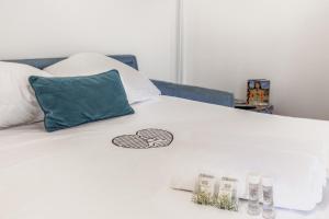 a bed with a white bedspread with a heart on it at Studio Faidherbe - Welkeys in Les Lilas +4 photos