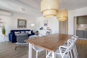 comedor y sala de estar con mesa de madera y sillas en Superb 3 stars flat w balcony - Saint-Jean-de-Luz - Welkeys, en San Juan de Luz