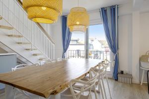 comedor con mesa de madera y sillas en Superb 3 stars flat w balcony - Saint-Jean-de-Luz - Welkeys, en San Juan de Luz