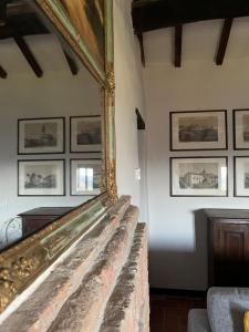 Country House Ca' di Nieri - The Saints' Lodge في Monte Santa Maria Tiberina: مرآة معلقة على جدار في الغرفة