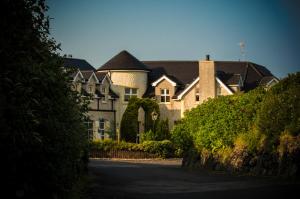 a large house with a driveway in front of it at Crockatinney guest house in Ballintoy