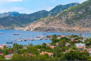 a view of a town and a harbor with boats at Defne Residence Selimiye in Marmaris