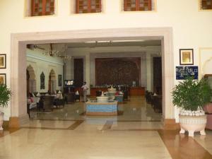 a lobby with chairs and tables in a building at Taj Hari Mahal Jodhpur in Jodhpur +50 photos