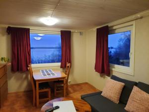 a small living room with a table and a couch at Björboholm in Gråbo